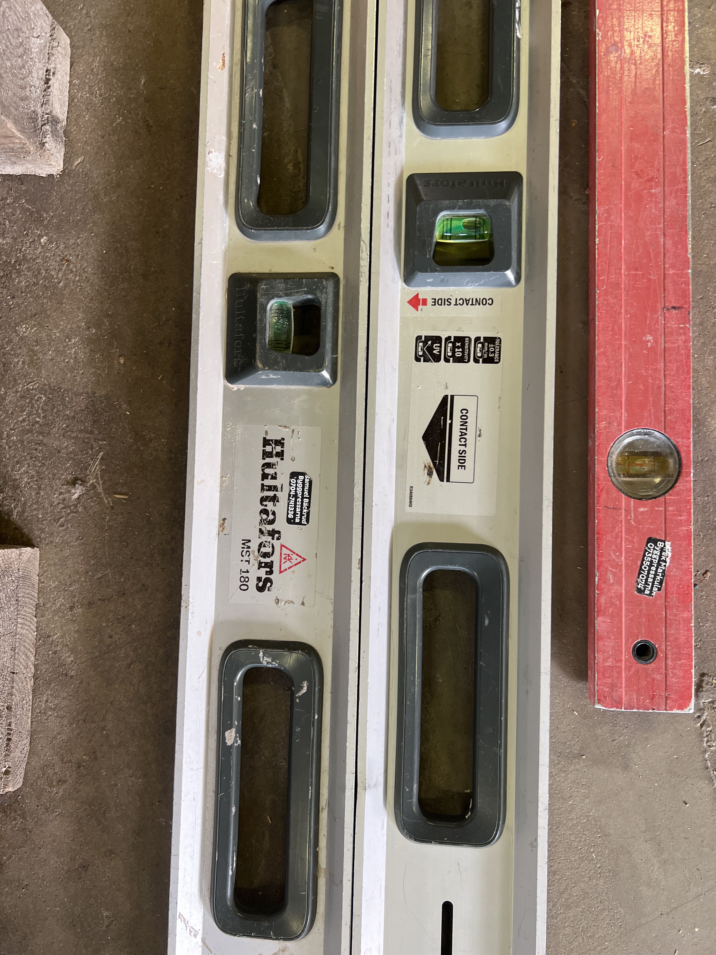 Various construction accessories spirit levels, work stands, screw ...