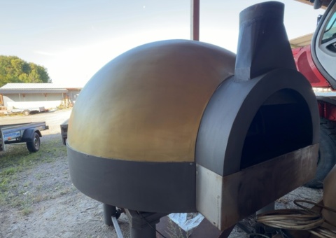 Dome-shaped pizza oven on stand