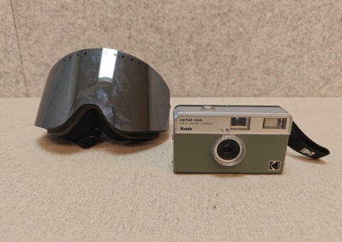 Ella ski goggles and Kodak analog camera