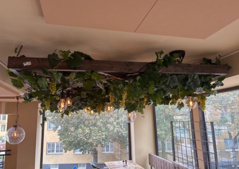 Lamp installation on a stand with ceiling lamps and artificial flowers