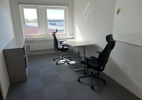 Office workstation with height-adjustable desk and furnishings