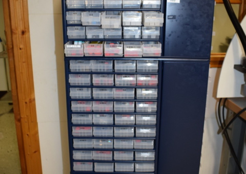 4-sided assortment cabinet on wheels with various hardened materials etc.