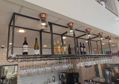 Ceiling-mounted bar shelf with glass holder