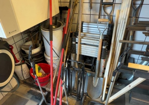 Everything in the corner - ladders, brooms and snow shovels