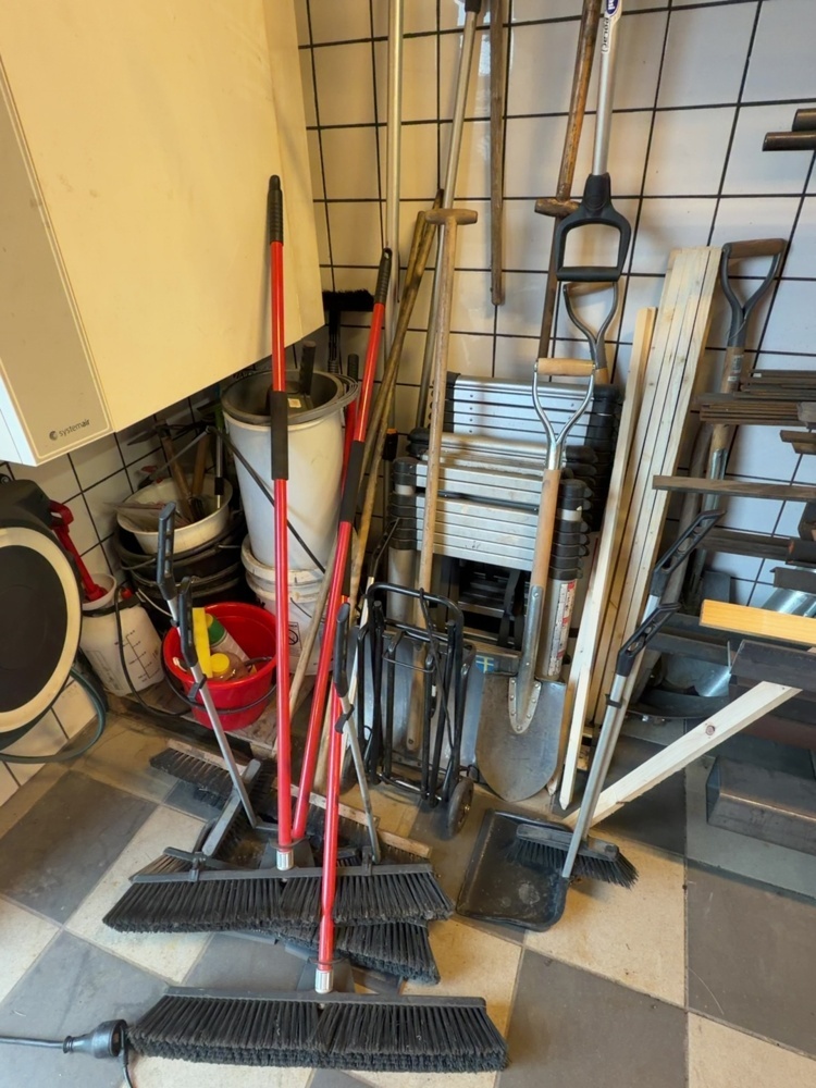 1574923-1 Everything in the corner - ladders, brooms and snow shovels
