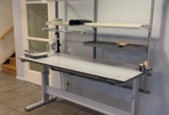 1594885 Height-adjustable packing bench with scales and lighting