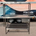 1607923-1 Begagnad rostfri bänk med överhylla på ståndare.