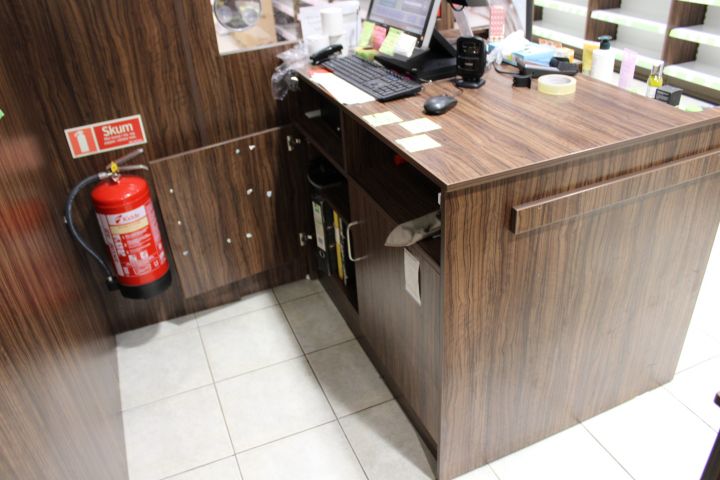 630152-10 Checkout counter with several parts in wood laminate