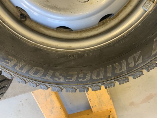 824564-3 6 studded C-tires on rim, Nissan Cabstar