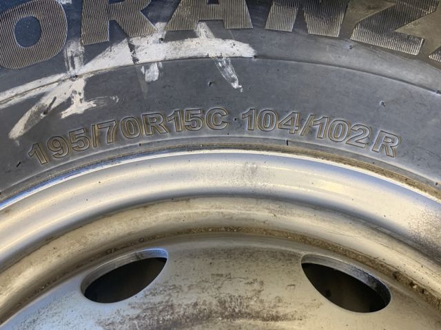 824564-6 6 studded C-tires on rim, Nissan Cabstar