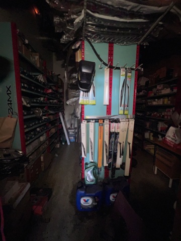 921201-2 Shelves with spare parts for older Citroën 60s-90s, as well as spare parts, oils, exhaust pipes