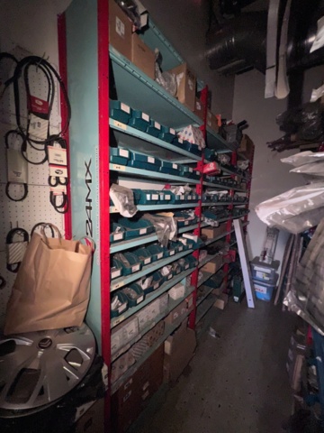 921201-3 Shelves with spare parts for older Citroën 60s-90s, as well as spare parts, oils, exhaust pipes