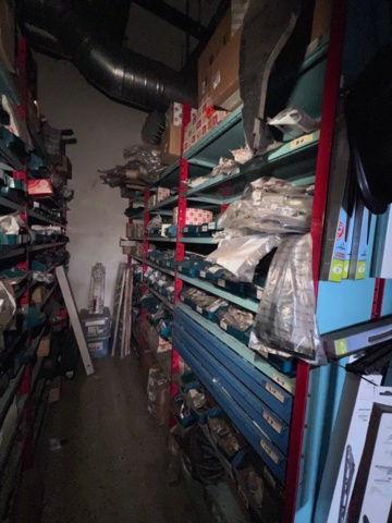 921201-4 Shelves with spare parts for older Citroën 60s-90s, as well as spare parts, oils, exhaust pipes