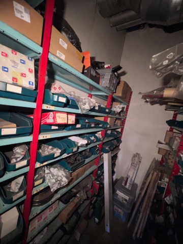 921201-6 Shelves with spare parts for older Citroën 60s-90s, as well as spare parts, oils, exhaust pipes