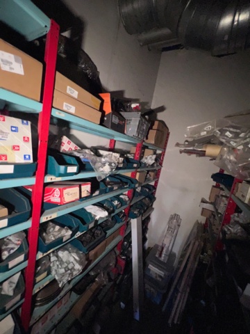 921201-7 Shelves with spare parts for older Citroën 60s-90s, as well as spare parts, oils, exhaust pipes