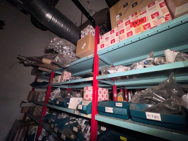 921201-13 Shelves with spare parts for older Citroën 60s-90s, as well as spare parts, oils, exhaust pipes