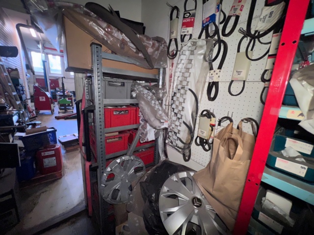 921201-19 Shelves with spare parts for older Citroën 60s-90s, as well as spare parts, oils, exhaust pipes