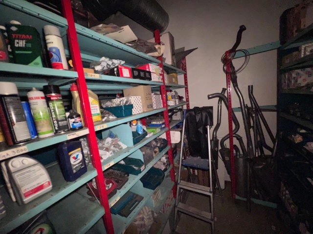 921201-23 Shelves with spare parts for older Citroën 60s-90s, as well as spare parts, oils, exhaust pipes