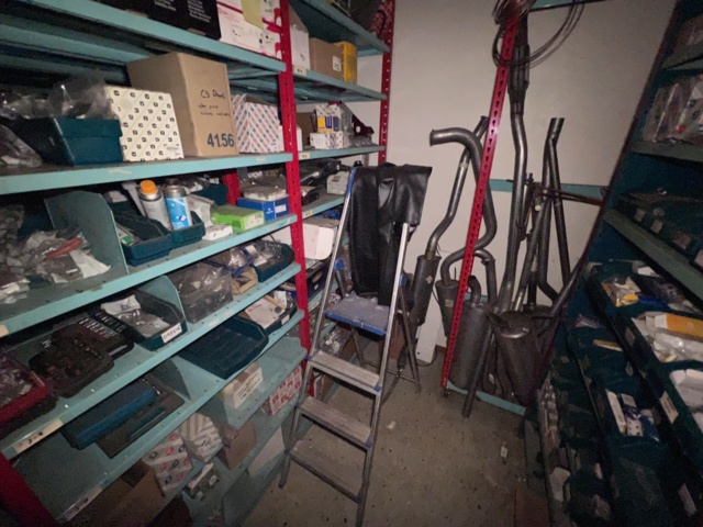 921201-24 Shelves with spare parts for older Citroën 60s-90s, as well as spare parts, oils, exhaust pipes
