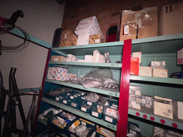 921201-26 Shelves with spare parts for older Citroën 60s-90s, as well as spare parts, oils, exhaust pipes