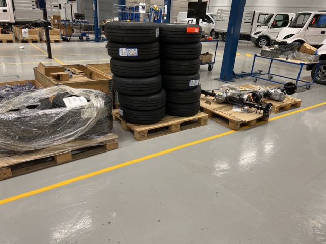 921812-2 4 pallets with tires, rims and axles