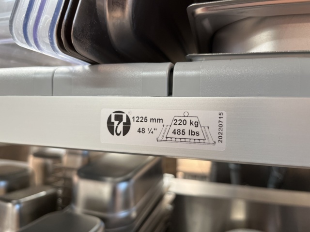 921075-11 Modular shelf with a large collection of restaurant accessories (canteens, tins, scales, etc.).