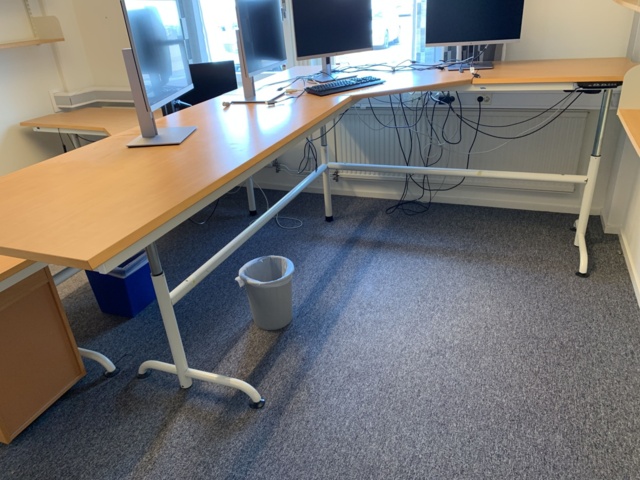 992594-3 Office furniture: Electric raise/lower desk, 4 HP 24" computer monitors, wall shelves, etc.