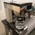 1013170-7 Coffee room with table, 2 chairs, 2 coffee makers, clothes hangers, etc