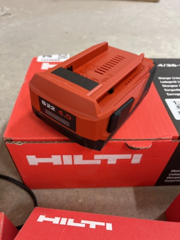 1029886-6 3 new Hilti batteries, 1 new Hilti charger and older charger with battery