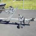 1035933-34 Buster aluminum boat on trailer and 4-stroke engine