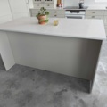 1130663-2 Fäviken Sand showroom kitchen with stone countertops and appliances from Electrolux