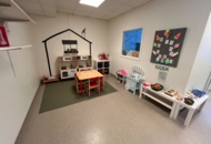 1424075 Playroom with furniture and toys - table, chairs, play kitchen, children's armchairs, storage