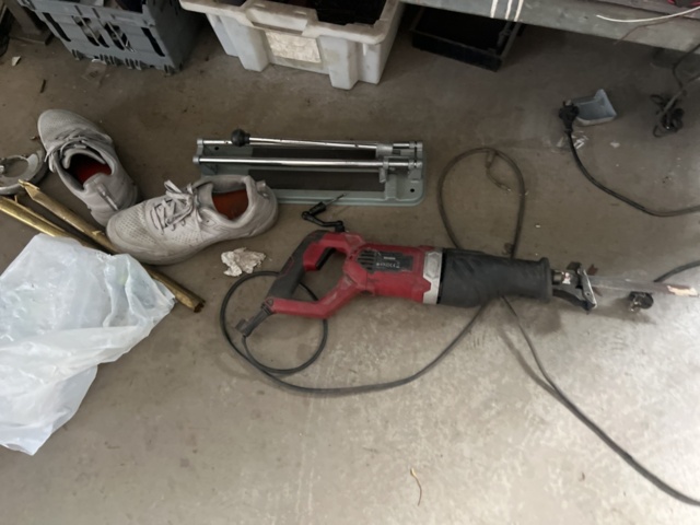 1469591-2 Workshop bench with mixed hand and power tools.