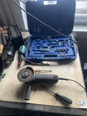 1469591-4 Workshop bench with mixed hand and power tools.