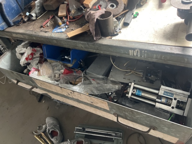 1469591-5 Workshop bench with mixed hand and power tools.