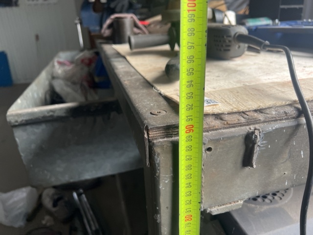 1469591-10 Workshop bench with mixed hand and power tools.