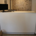 1476282-4 Reception desk including computer screen and revolving door